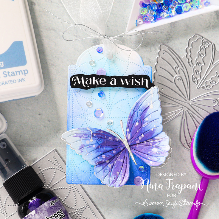 STAMPtember® Party Nina-Marie Trapani Layered Cosmic Butterfly and Rhythm Link Pinpoint Plate dies, Purple Fields sequins, and Reverse Birthday Wishes sentiment strips,